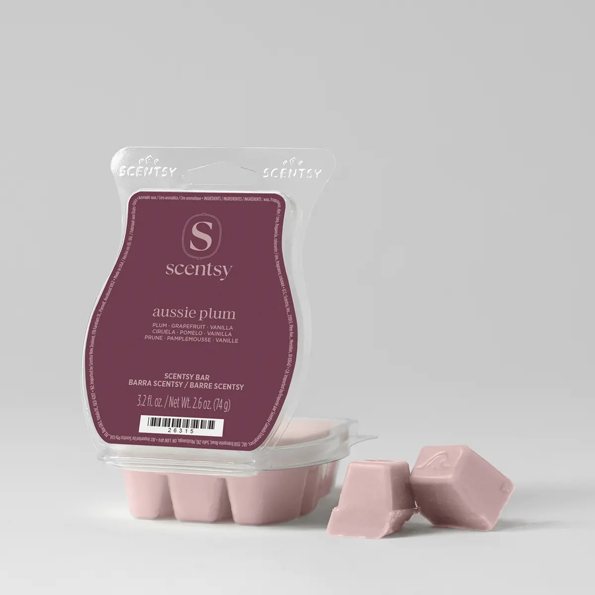 Pink wax bar segments beside a burgundy packaged Aussie Plum Scentsy Bar with clear plastic clamshell and perforated tear-open top