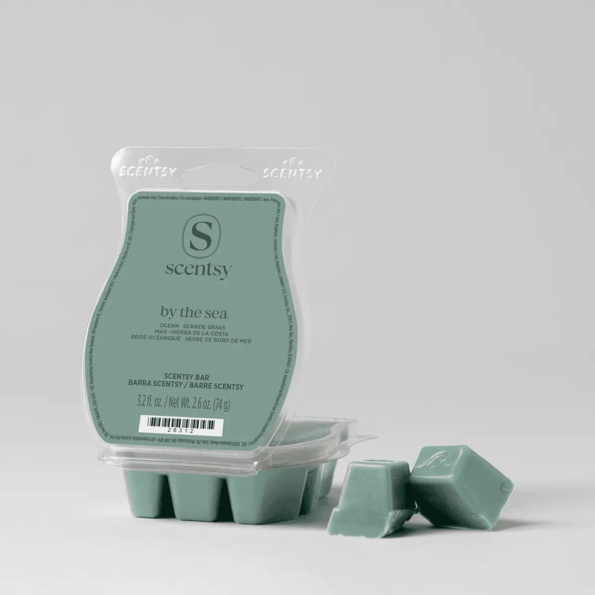 Pale seafoam-green wax melts in a clamshell container with a peelable label reading "By the Sea Scentsy Bar", with three individual wax segments displayed separately in front