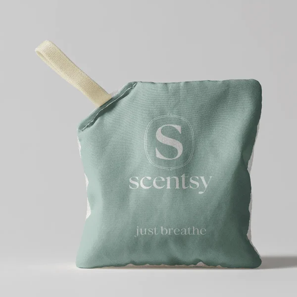 Sage-green fabric Scent Pak with cream ribbon loop and embossed Scentsy branding, the Just Breathe Scent Pak