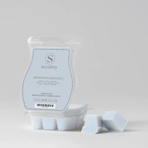 Pale blue clamshell package containing white wax bar segments and a label reading "Newborn Nursery Scentsy Bar", with three individual wax cubes displayed in front
