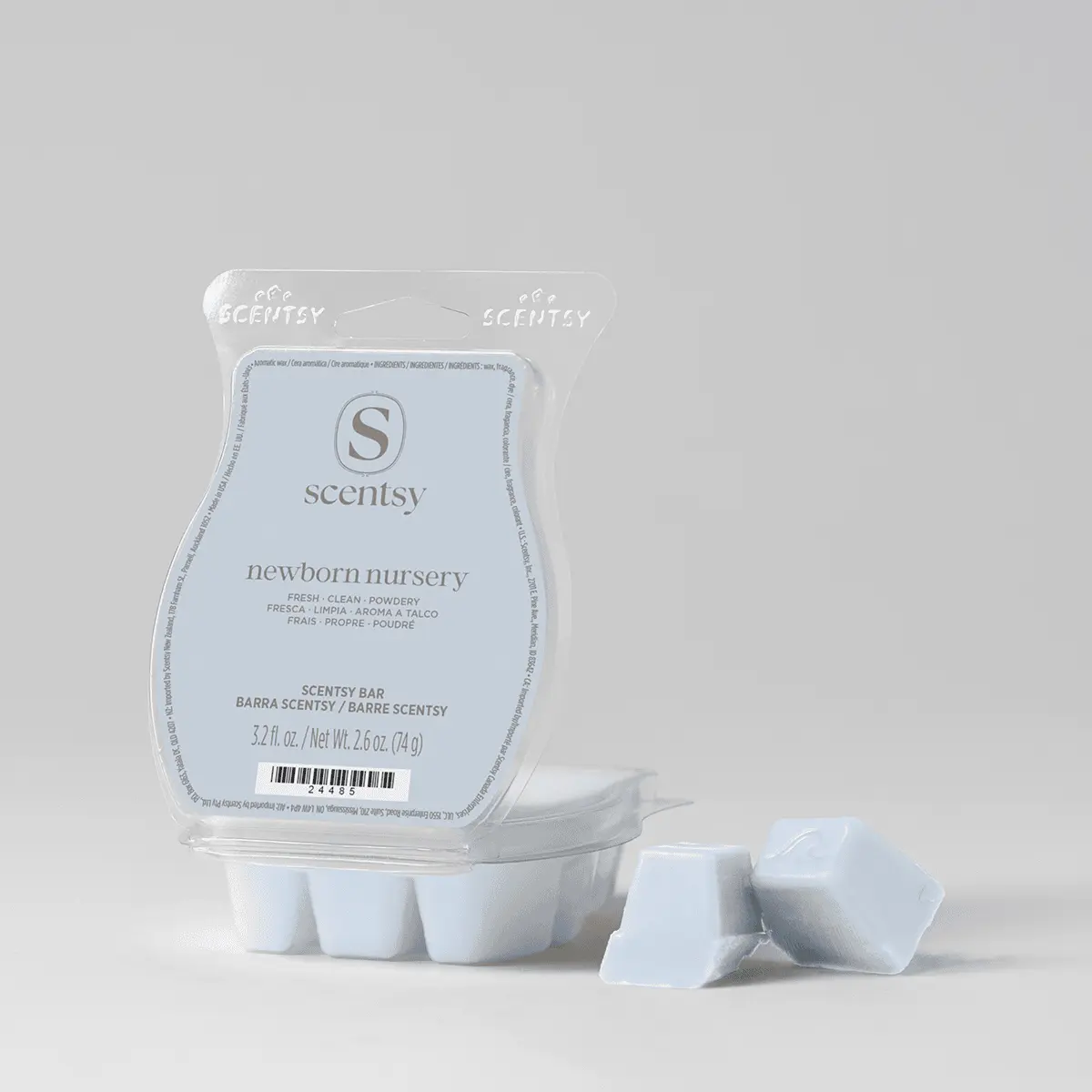 Pale blue clamshell package containing white wax bar segments and a label reading "Newborn Nursery Scentsy Bar", with three individual wax cubes displayed in front
