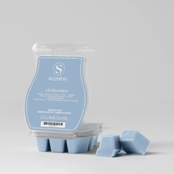 Light blue wax bar with scalloped edges in a clear clamshell package, the Clothesline Scentsy Bar, shown with three detached wax cubes beside the packaging