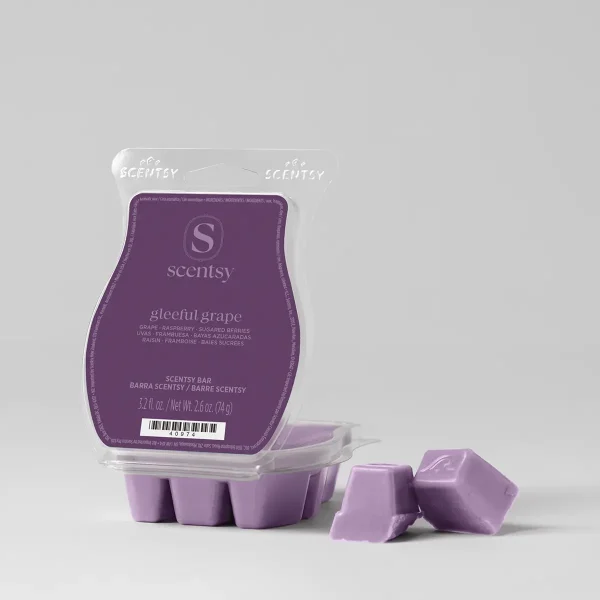 Purple wax bar in a clear clamshell with a plum label, two square lilac cubes broken off beside it, the Gleeful Grape Scentsy Bar