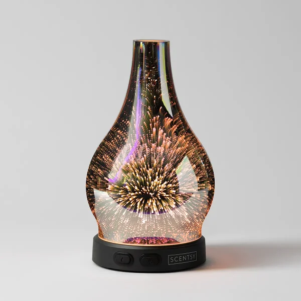 Teardrop-shaped glass diffuser with a dimensional starburst pattern in gold and copper that creates a radiant light effect when illuminated, the Stargaze - Scentsy Diffuser, mounted on a black base with control buttons