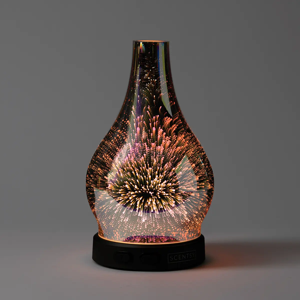 Teardrop-shaped glass diffuser with a dimensional starburst light pattern radiating gold, pink and purple hues, the Stargaze Scentsy Diffuser