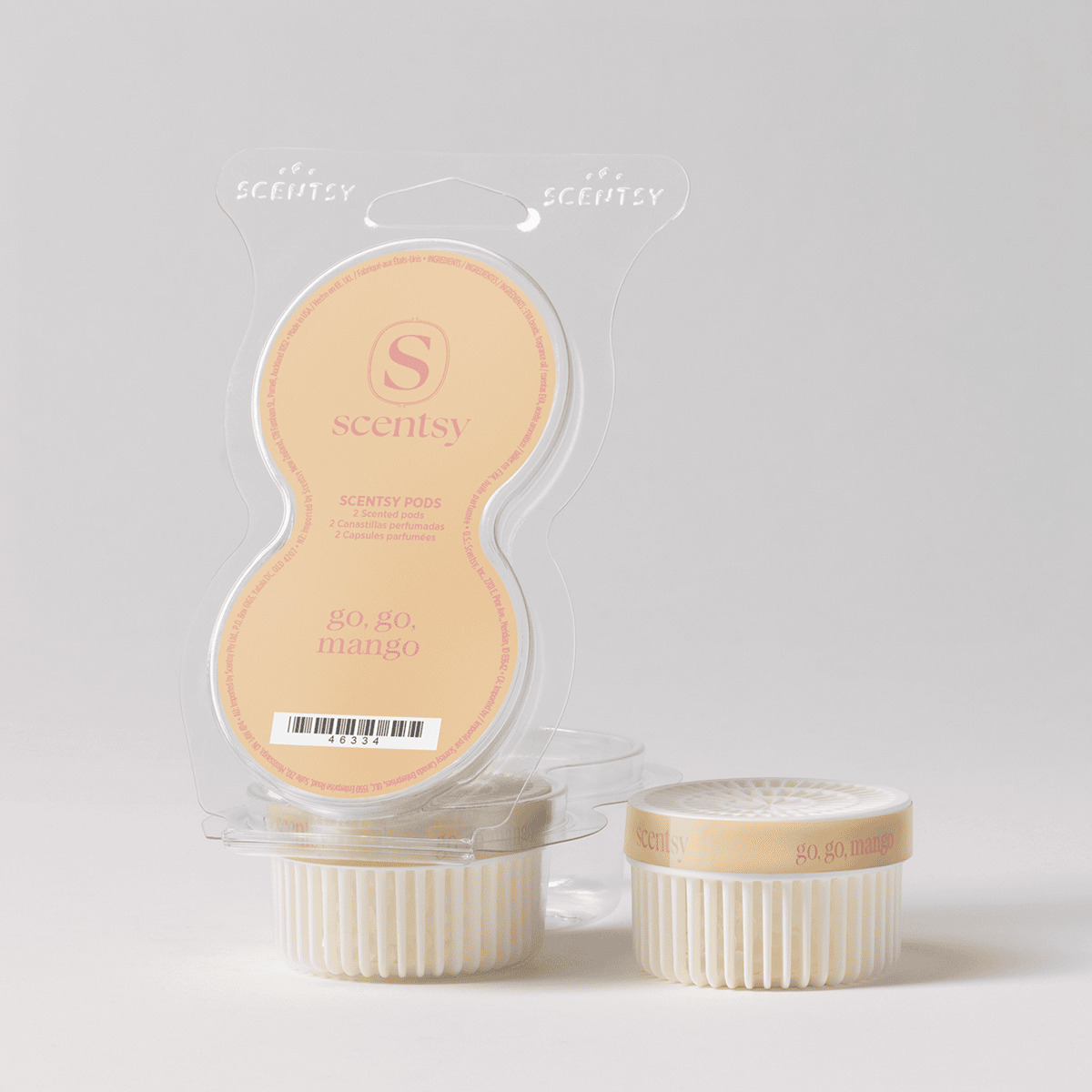 Two cream-coloured ridged Scentsy Pods with peach labels and packaging showing the Go, Go, Mango Scentsy Pods branding and Scentsy logo