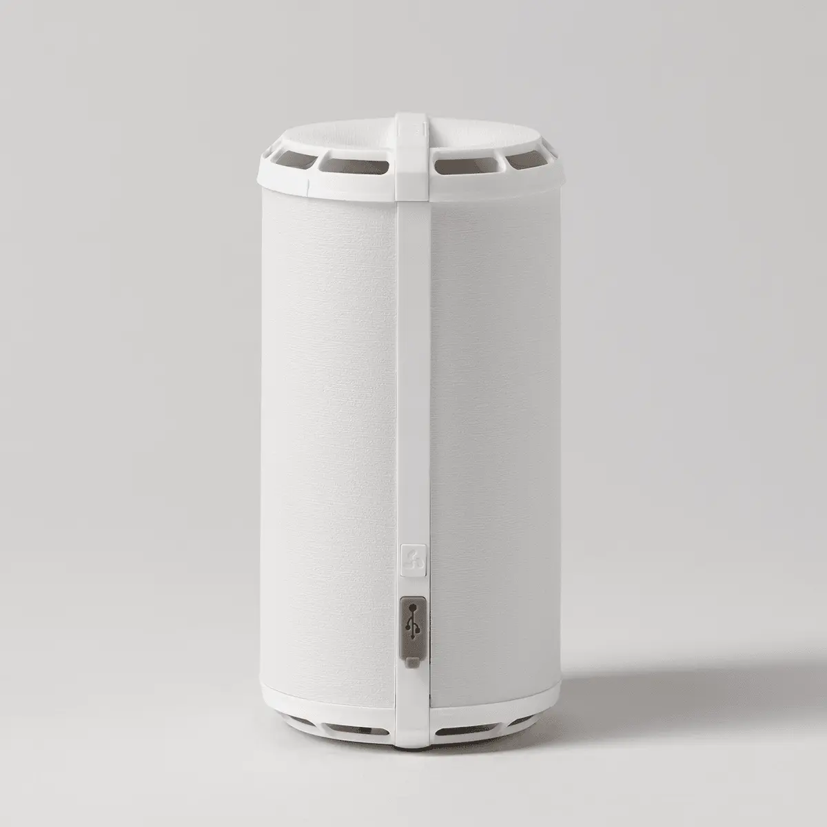 Compact white cylindrical diffuser with ventilation slots around the top and bottom, and a front-facing USB port symbol
