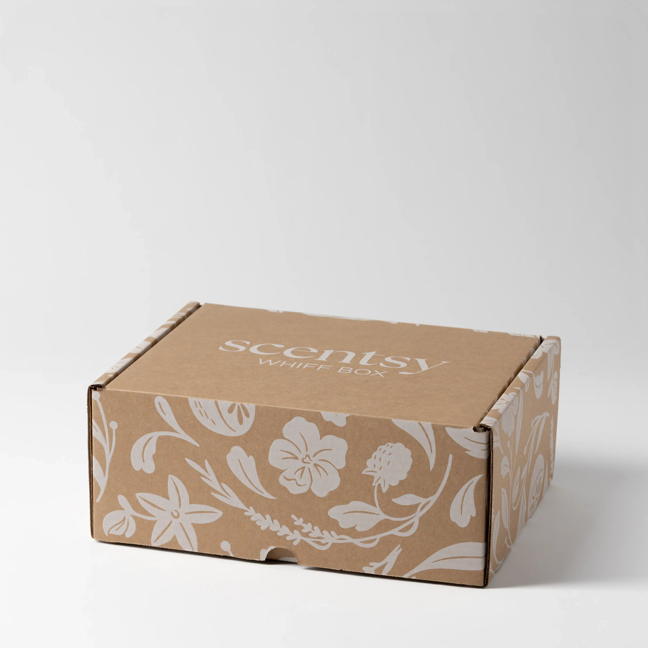 Kraft cardboard box with cream floral and botanical print design, labelled Scentsy Whiff Box on the lid