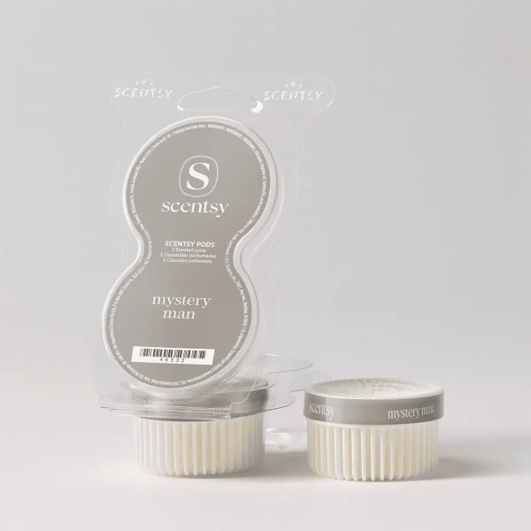 Two cream-coloured Scentsy Pods with grey labels reading "mystery man" beside their clear plastic clamshell packaging, the Mystery Man Scentsy Pods