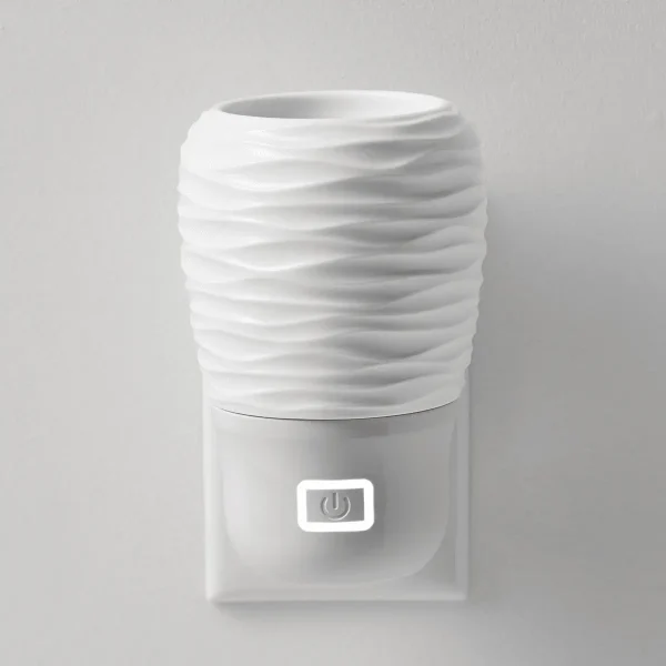 White ceramic Scentsy Air Mini - Spin diffuser with horizontal wave texture pattern wrapping around the cylindrical body and a power button on the front