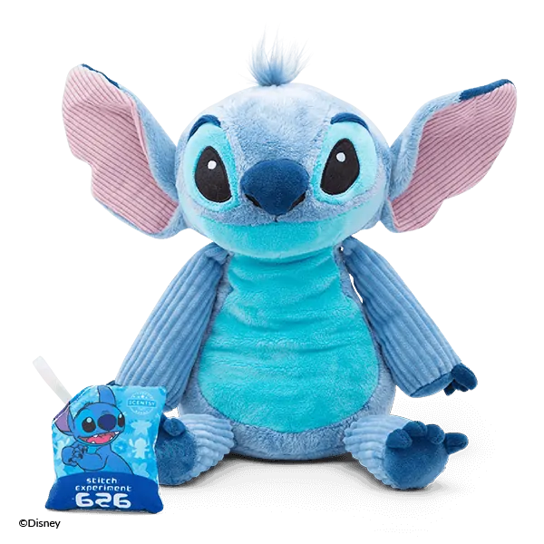 Blue plush character with large ears, big eyes, and a wide smile, wearing textured fabric details, the Disney Stitch Scentsy Buddy, shown with its small tag attached