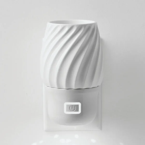 White ceramic diffuser with diagonal ridge texture, cylindrical upper chamber and rectangular base with power button, the Scentsy Air Mini+ - Swivel