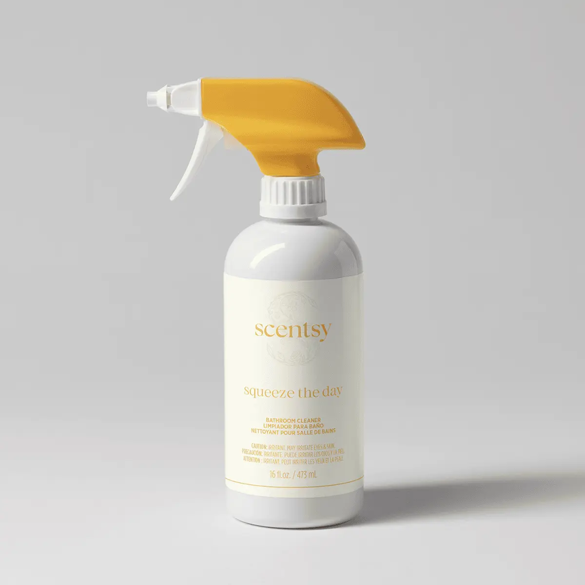 White spray bottle with a yellow and white trigger nozzle and a soft cream label, the Squeeze the Day Bathroom Cleaner