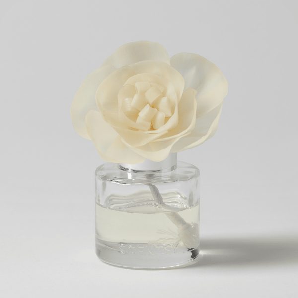Cream-coloured fabric rose with layered petals and white centre squares, seated in a clear glass diffuser bottle filled with pale liquid, the Vanilla Bean Buttercream - Buttercup Belle Fragrance Flower