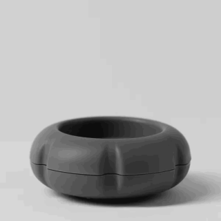 Slate-coloured donut-shaped Scentsy Air Solo diffuser with a wide central opening and dimensional ribbed panels, shown closed with a seam line running horizontally around the middle