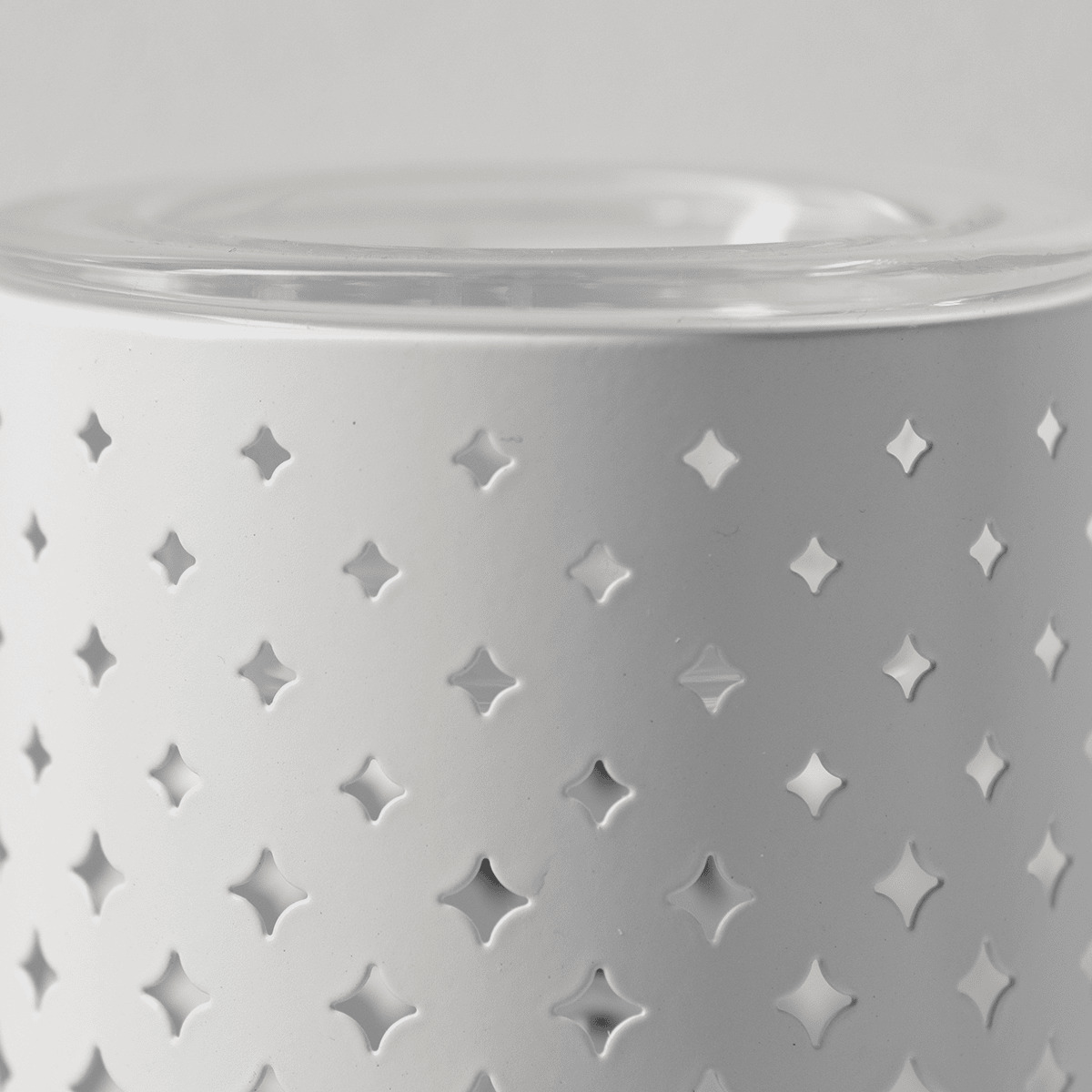 White ceramic mini warmer with a grid of embossed four-pointed stars and a clear glass lid, the Light From Within Mini Scentsy Warmer
