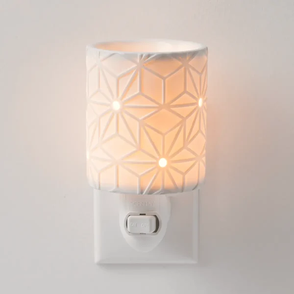 White ceramic plug-in warmer with a geometric star pattern that glows warmly when lit, the Salerno Mini Scentsy Warmer