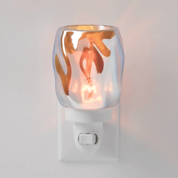 White plug-in warmer with iridescent glass top featuring abstract brushstroke patterns in orange and copper tones, lit to show warm glow, the Bubbled - Iridescent Mini Scentsy Warmer