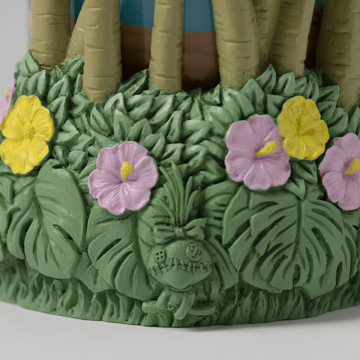 Green ceramic warmer base sculpted with tropical foliage and pink and yellow hibiscus flowers, topped with tan barrel cactus stems, the Disney Lilo & Stitch: Aloha-Ohana Scentsy Warmer