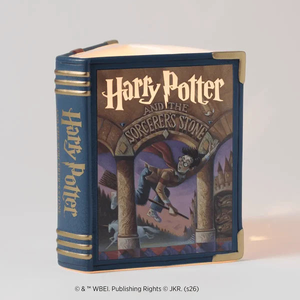 Harry Potter and the Sorcerer's Stone Scentsy Warmer - Navy book-shaped Scentsy Warmer designed as Harry Potter and the Sorcerer's Stone, with gold spine lettering, brass corners, and cover artwork depicting Harry flying on a broomstick through a magical archway