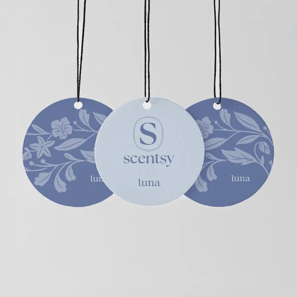 Three circular hanging fragrance tags with black cords: two in deep blue with floral leaf designs, one in pale blue with the Scentsy logo, all labelled luna, the Luna Scent Circle 3-pack