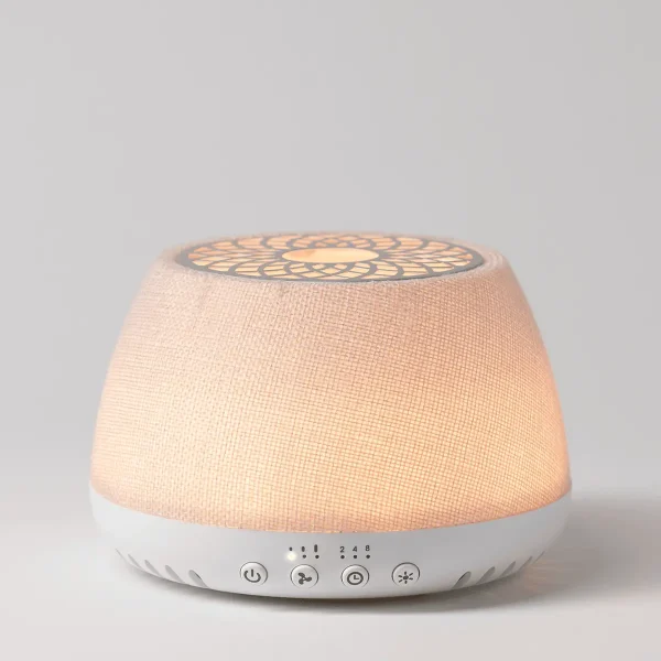 Scentsy Air Quad White - Linen diffuser with a white base, fabric-wrapped upper half in soft peachy-pink, illuminated top with geometric pattern, and touch-sensitive controls on the front