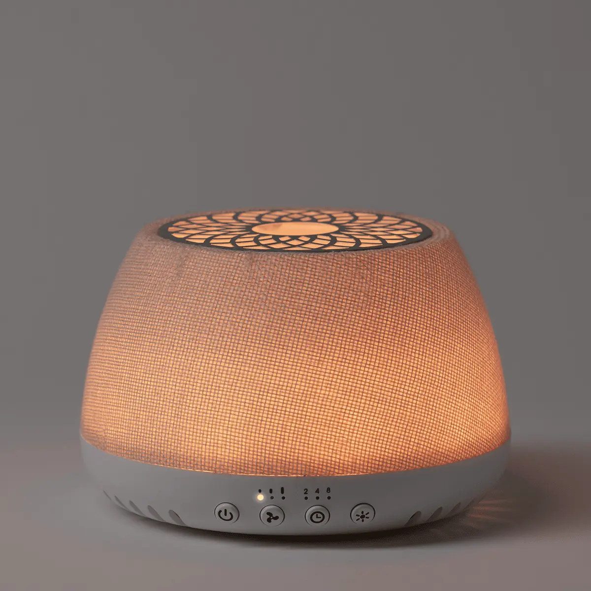 Dome-shaped Scentsy Air Quad diffuser with a woven linen-textured top glowing warm orange, white base with control buttons and LED indicator lights