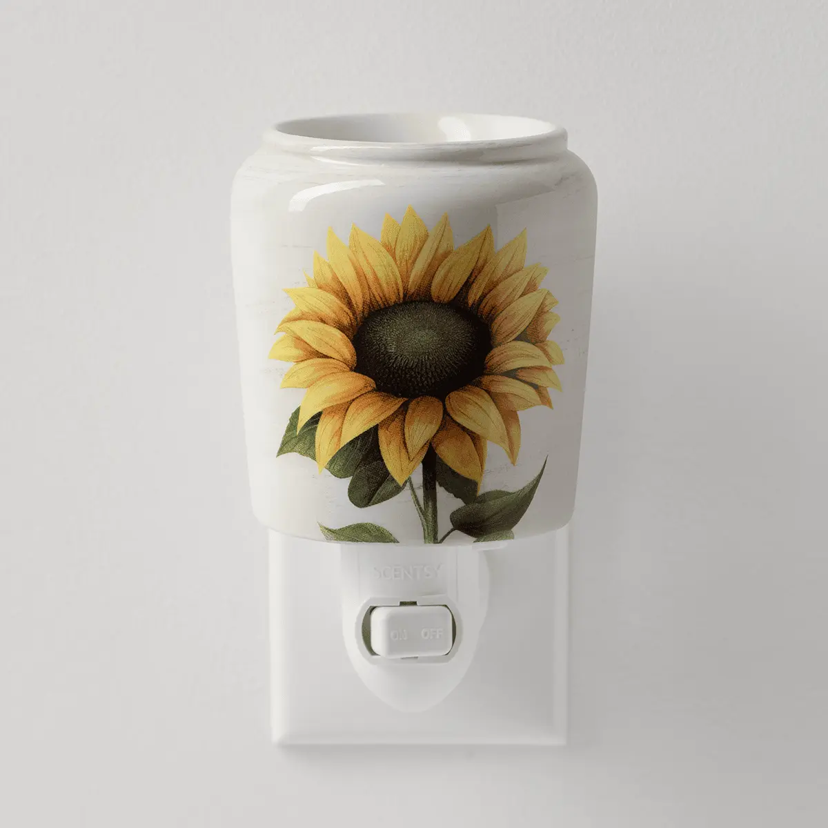 White ceramic mini warmer with a sunflower illustration, mounted on a white wall plug base with an on/off switch