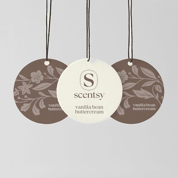 Three circular hanging Scent Circles with black cords and small white beads: cream centre disc with Scentsy logo and "vanilla bean buttercream" text, flanked by two taupe discs with floral damask pattern, for the Vanilla Bean Buttercream Scent Circle 3-pack