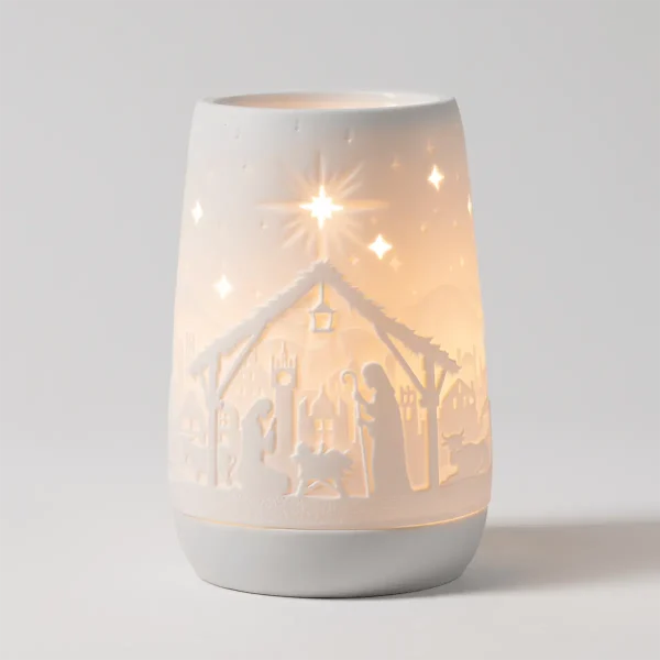 White ceramic warmer with a cutout nativity scene casting warm light, stars above the manger, the Radiant Beams Scentsy Warmer