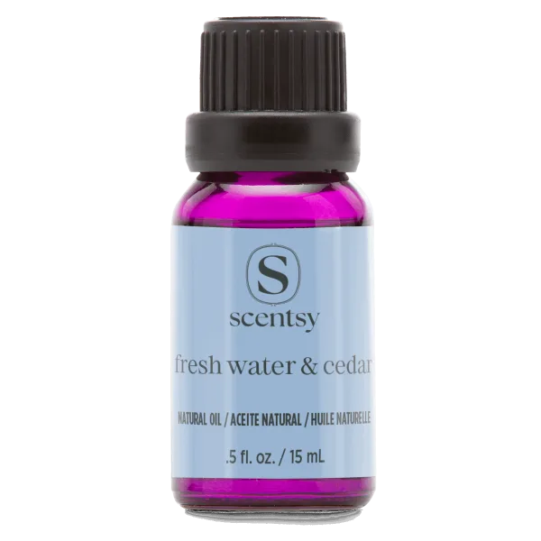 Small glass bottle with black screw cap containing bright magenta natural oil, labeled Fresh Water & Cedar Natural Oil Blend with Scentsy branding on light blue label