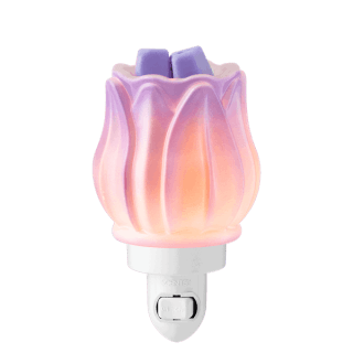 Translucent pink and purple petal-shaped mini warmer with gradient lighting effect and two purple wax bars inside, the Prismatic Petal Mini Scentsy Warmer, mounted on a white plug base
