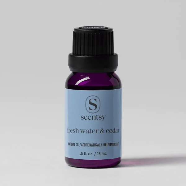 Fresh Water & Cedar Natural Oil Blend - Dark purple glass bottle with black ribbed cap and light blue label featuring the Scentsy logo, containing Fresh Water & Cedar Natural Oil Blend, 15 mL