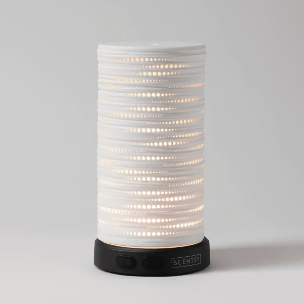 White cylindrical diffuser with horizontal rows of perforated dots that glow warmly when lit, sitting on a black base with Scentsy branding, the Gleam - Scentsy Diffuser