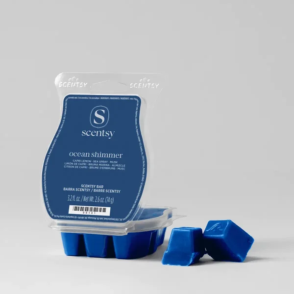 Blue Scentsy wax bar in a clear clamshell package with blue label showing "ocean shimmer" fragrance details, with three separated blue wax cubes displayed in front, the Ocean Shimmer Scentsy Bar