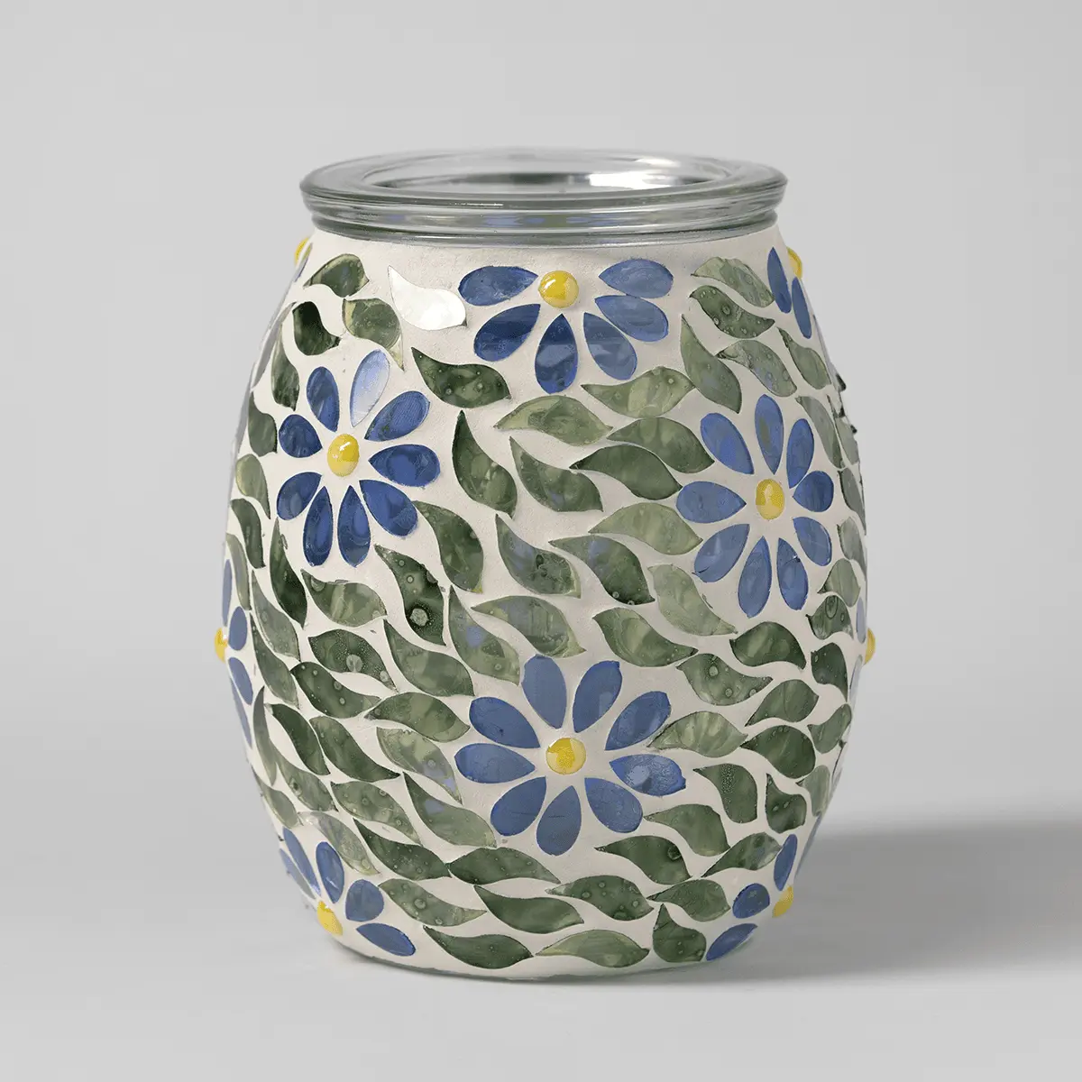 Ceramic warmer with a cream base decorated with blue daisies, yellow centres, and green leaves, topped with a glass lid, the Periwinkle Petals Scentsy Warmer