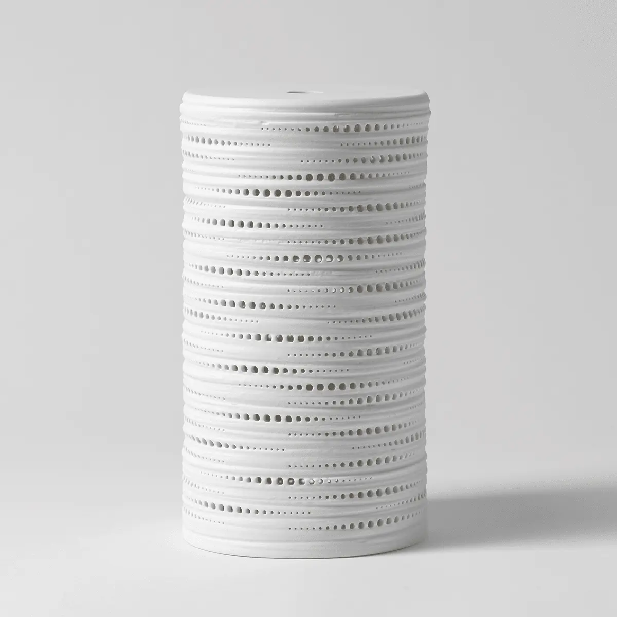 White cylindrical diffuser shade with horizontal bands perforated with small circular cutouts throughout, the Shade Only - Gleam