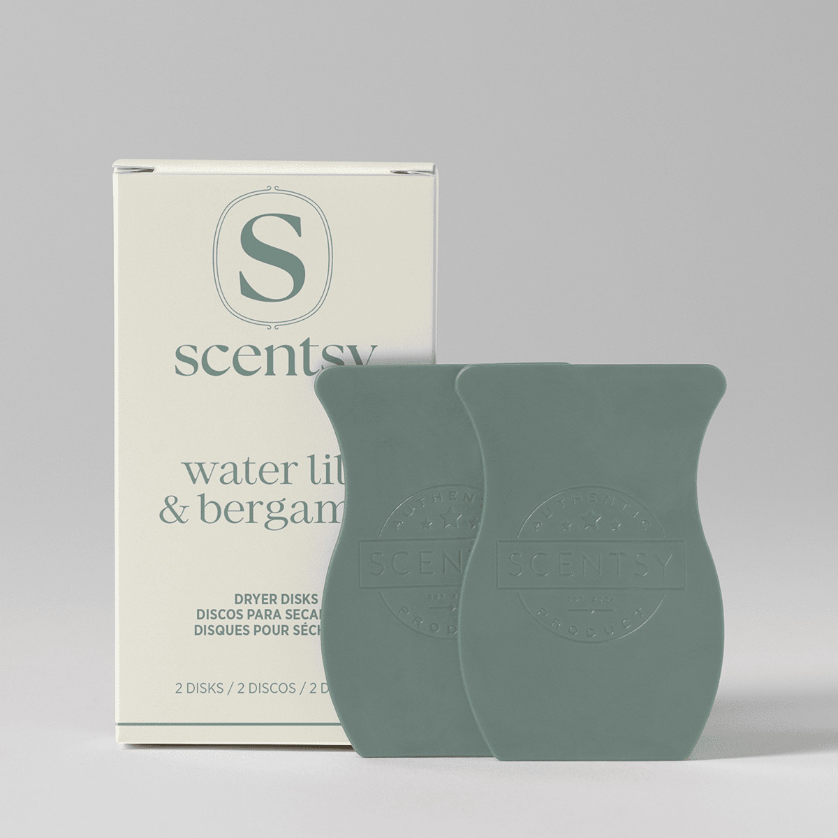Water Lily & Bergamot Dryer Disks - Sage-green waxy dryer disks with embossed Scentsy branding, displayed alongside cream packaging for Water Lily & Bergamot Dryer Disks