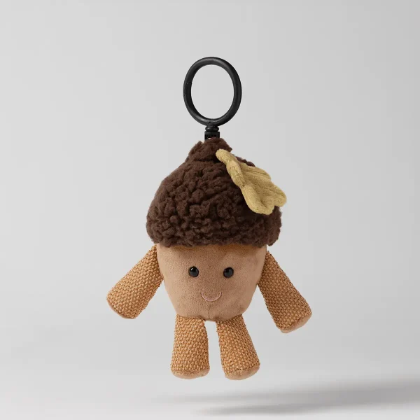Plush acorn-shaped toy with a brown textured cap, cream knit body and limbs with embroidered smile, yellow leaf detail, and black loop attachment, Ayla the Acorn Scentsy Buddy Clip