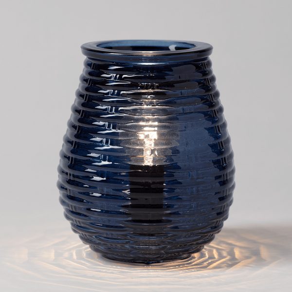 Deep blue glossy ceramic warmer with a rippled horizontal texture pattern, the Azure Ripples Scentsy Warmer, casting warm light through the ridged surface