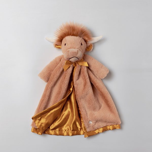 Soft plush Highland cow with reddish-brown fur, white horns, and embroidered features, wearing a tan wool cape with a gold satin lining and matching bow, Hamish the Highland Cow Scentsy Blankie Buddy