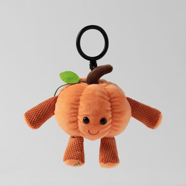Plush pumpkin character with orange body, brown textured limbs, smiling face, green leaf and brown stem on top, black stroller clip attachment, Jinx the Pumpkin Buddy Clip