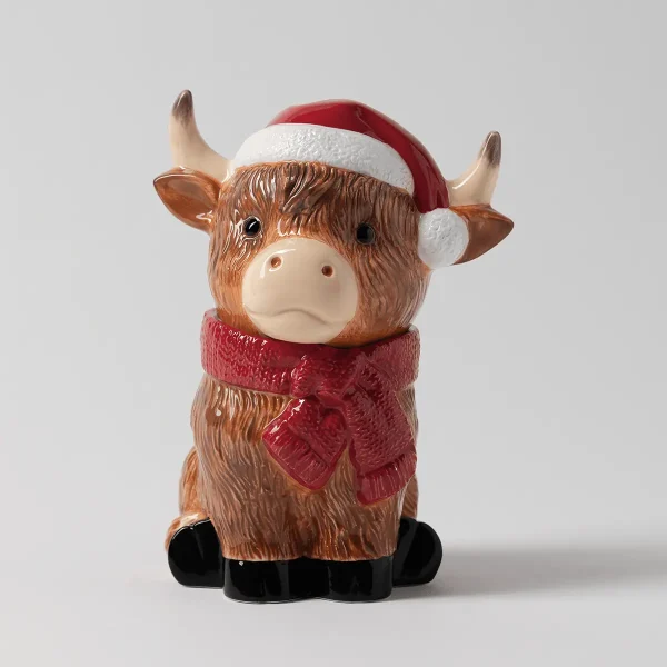 Ceramic Highland cow with shaggy brown fur, a red Santa hat and a knitted red scarf, the Jolly Ol' Saint Moo Scentsy Warmer