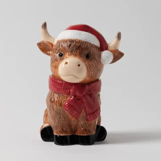 Ceramic Highland cow warmer with shaggy brown fur, a red Santa hat and scarf, the Jolly Ol' Saint Moo Scentsy Warmer