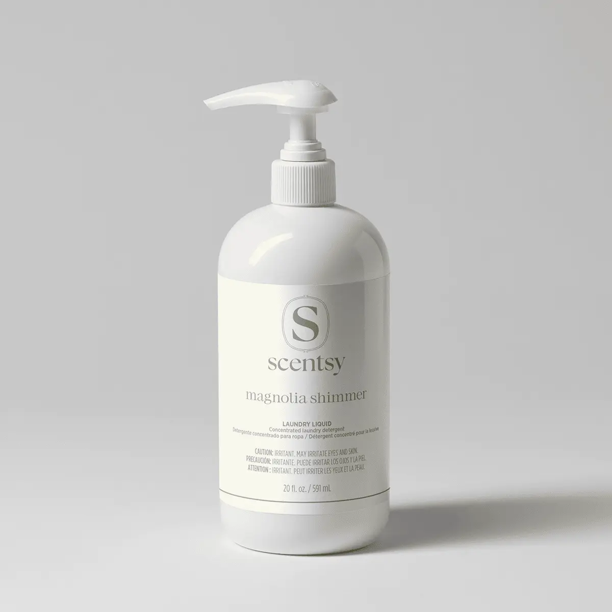 White pump bottle of Magnolia Shimmer Laundry Liquid with Scentsy branding, 20 fl oz, on a neutral grey background