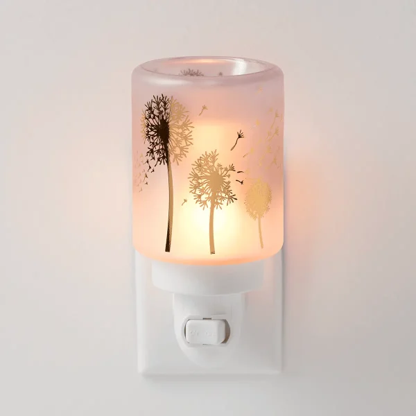 Frosted glass wall-plug warmer with dandelion silhouettes and flying seeds in warm gold and brown tones, glowing warm amber when lit, the Wishbloom Mini Scentsy Warmer