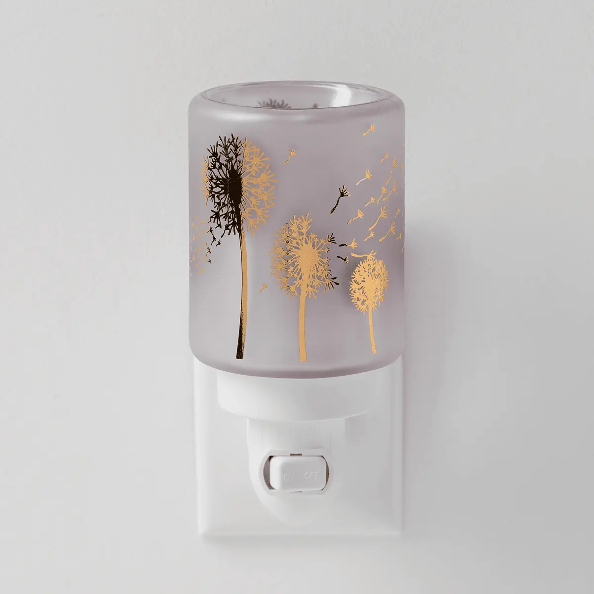 Frosted grey mini warmer with gold and black dandelion design and dispersing seeds, white plug base with control button, the Wishbloom Mini Scentsy Warmer
