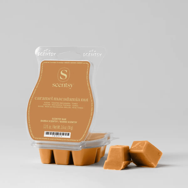 Caramel Macadamia Nut Scentsy Bar in a clear plastic clamshell with an orange label, six wax cubes visible in the molded tray below, with two additional cubes displayed separately