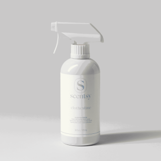 White spray bottle with trigger dispenser labeled Scentsy Clothesline Scentsy Fresh fabric spray, 16 fl oz, against a neutral background