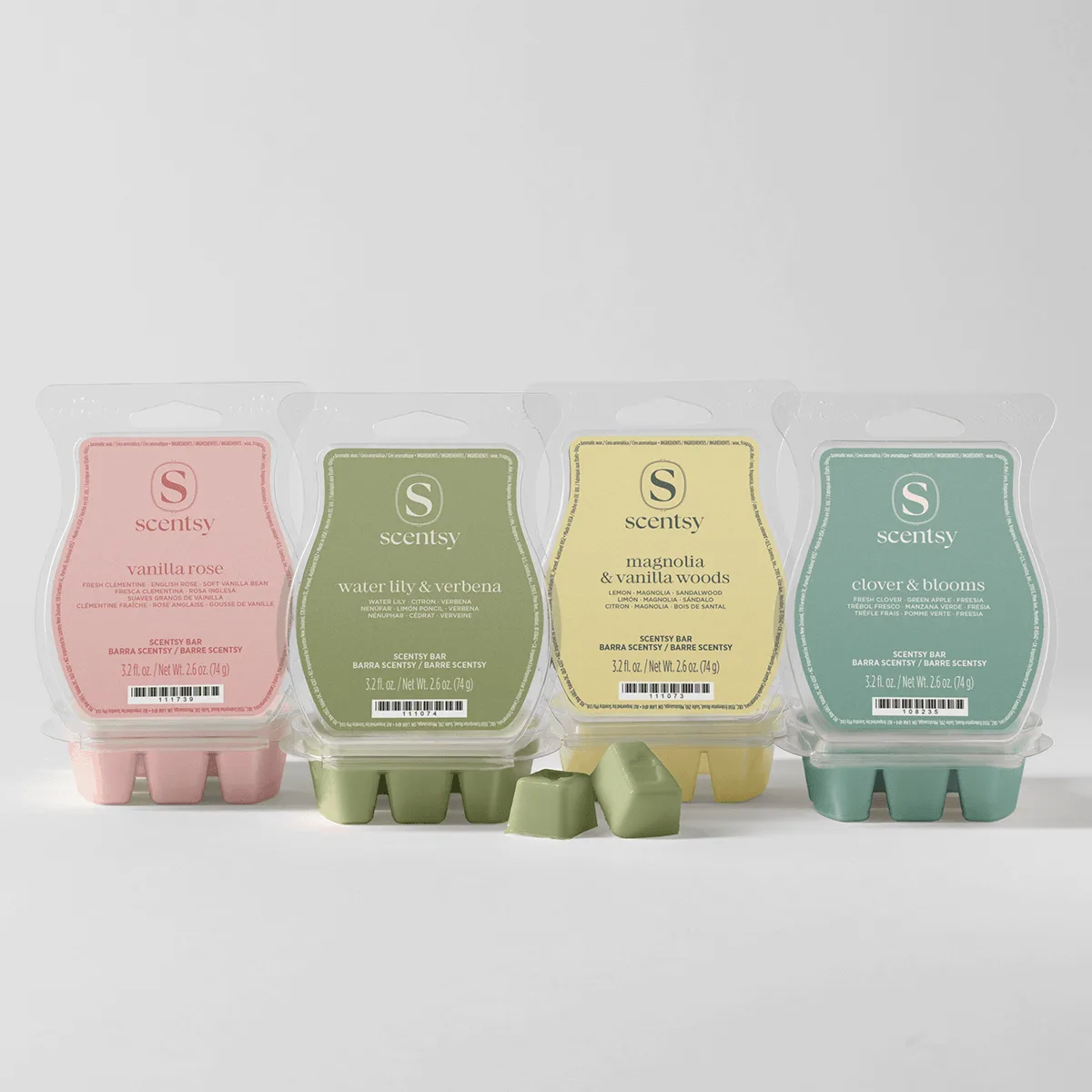 Garden Collection Scentsy Bar 4-pack - Four Scentsy Bars in the Garden Collection 4-pack: pink Vanilla Rose, sage green Water Lily & Verbena, pale yellow Magnolia & Vanilla Woods, and dusty teal Clover & Blooms, each in clear clamshell packaging with six wax bars visible in front